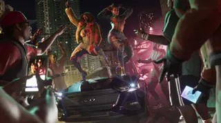 Two people dancing on a car hood in Grand Theft Auto 6.