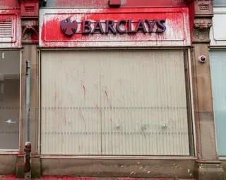 Barclays bank in Burnley, Lancashire, daubed with red paint and with its large window broken