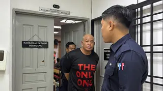 Mohamed Anim Atam is led out of the courtroom after he pleads guilty at the Johor Bahru Magistrate’s Court to charges of insulting Islam on August 21, 2026. — Picture by Ben Tan