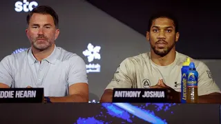 Eddie Hearn and Anthony Joshua sit at a table