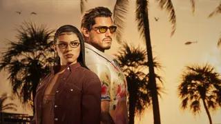 Two smartly dressed characters, one male, one female, both Latino, stand back to back in front of palm trees as the sun goes down.