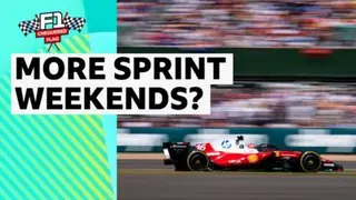 A Formula 1 car speeds past a blurred crowd