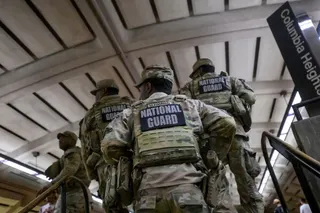 Members of the Arkansas National Guard continue their patrol after carrying an elderly woman in her wheelchair down the steps to the train platform due to an out-of-service elevator at the Columbia Heights metro station, Monday, Aug. 10, 2026, in Washington. (AP Photo/Rod Lamkey, Jr.)