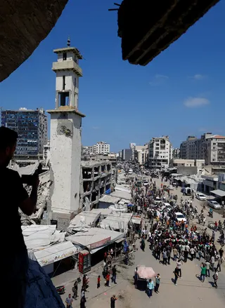 Palestinians attend the funeral of 50 people from three families killed during the war and whose bodies were retrieved from under the rubble recently, in Gaza City, on Aug 20. REUTERS FILE PIC