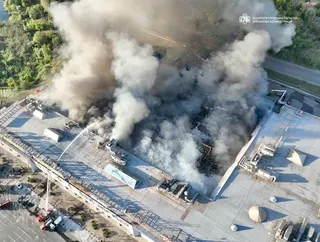 Firefighters work to extinguish a fire at a shopping centre following a Russian drone attack in Kryvyi Rih, Ukraine, on Friday. Photo: Ukrainian Military administration/AP