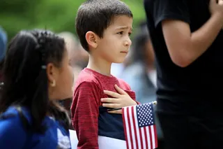 Children say the pledge of allegiance during a children’s citizenship ceremony hosted by US Citizenship and Immigration Services in 2018. Photo: Getty Images/AFP
