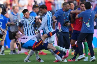 Argentina’s Leandro Paredes (centre) knocks down Spain’s Gavi after the World Cup final. Photo: AP