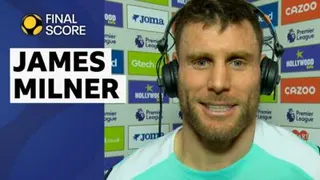 James Milner smiles in a blue and white Brighton training top
