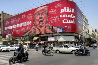 Motorists drive past a billboard pledging revenge against US President Donald Trump in Tehran last month. Photo: AFP/Getty Images/TNS