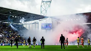 Feyenoord supporters set off fireworks and throw them onto the field and into the stands of SC Cambuur supporters during the Dutch Eredivisie match between SC Cambuur v Feyenoord