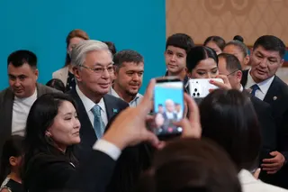 Tokayev poses for a picture with voters at a polling station during a snap parliamentary election in Astana, Kazakhstan, on Sunday. Photo: Reuters