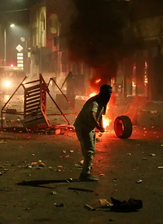 Fire burns on a street as demonstrators clash with security forces during a protest, following the sinking of a migrant boat bound for Italy, in Ben Guerdane, Tunisia, August 24, 2026. REUTERS/Ahmed Jarray