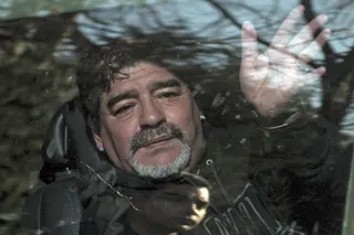 Argentina’s former football star Diego Armando Maradona waves to supporters as he leaves the funeral of his father Don Diego in Bella Vista, on the outskirts of Buenos Aires, on June 26, 2015. — AFP pic