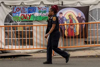 An Essex County police officer walks past a tent used by protestors as a base outside of Delaney Hall, in Newark, New Jersey, U.S., May 31, 2026.
