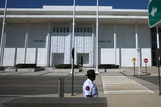 WASHINGTON, DC - AUGUST 25: A tarp remains in place on the facade of the John F. Kennedy Center for the Performing Arts on August 25, 2026 in Washington, DC. Lawyers for the center said a tarp originally set up outside during the removal of President Trump’s name will remain while crews conduct structural repairs. Since attempting to add President Trump's name to the center, ticket sales and fundraising efforts have collapsed, according to a Washington Post report. Kevin Dietsch/Getty Images/AFP