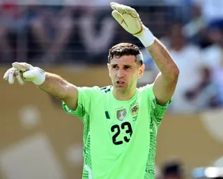 Emiliano Martínez gestures while playing for Argentina in July's World Cup final.