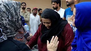 Javeria, mother of a newborn victim, is consoled following a deadly fire at the Pakistan Institute of Medical Sciences (PIMS) hospital in Islamabad, Pakistan, August 26, 2026