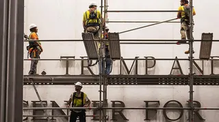 Workers put up scaffolding prior to the removal of President Donald Trump's name from the Kennedy Center on June 12, 2026 in Washington, DC.