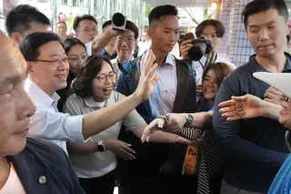 Chief Executive John Lee arrives at Un Chau Estate in Cheung Sha Wan. Photo: Karma Lo