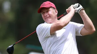 Sir Nick Faldo watches the ball down the fairway having driven from the tee