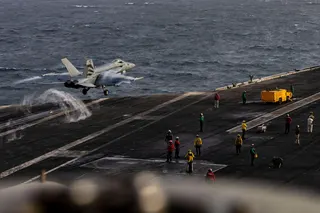 A US Navy photograph shows an F/A-18E Super Hornet launching from the flight deck of the USS Abraham Lincoln on July 31.