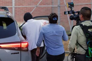 a man gets into a car followed by a camera operator