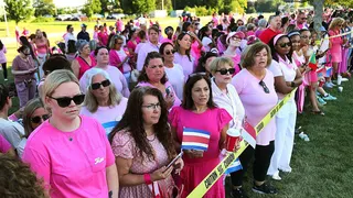 Women in pink shirts gather outside of Clancy's trial to support her