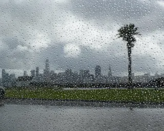 The San Francisco city skyline, as seen from Treasure Island, is photographed through a rain-spattered lens.