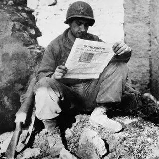 A man reading a newspaper.