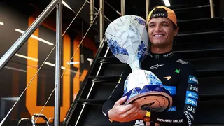 Lando Norris poses with the winner's trophy after winning the Dutch Grand Prix