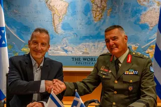 Director-general of the Israel Ministry of Defence Amir Baram, and his Greek counterpart, Ioannis Bouras, shake hands as they sign a US$3.5 billion defence export agreement in Tel Aviv on Monday. Photo: Israel Defence Ministry/Reuters