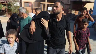 The mother of Amal Abu Khater, 10, is comforted outside Nasser hospital, in Khan Younis, southern Gaza (24 August 2026)