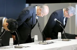 Then Dentsu president Tadashi Ishii (centre) bows as he announces his resignation on  December 28, 2016, after the  suicide of a young employee is linked to allegations of extreme overwork at the company. Photo: Jiji Press/AFP