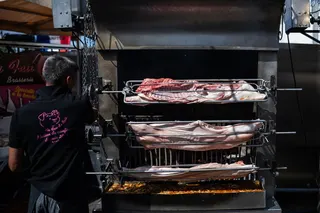 A man prepares racks of meat for roasting at a food stand during the agricultural fair in Chalons-en-Champagne, north-eastern France, on August 31, 2026. The European Union will suspend imports of Brazilian meat and other animal products from Thursday, Brussels said, pending assurances from Brazil that it is complying with the bloc’s animal health rules. — AFP pic