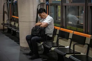 A man sleeps on a bench at a railway station in Tokyo on Tuesday. Photo: AFP