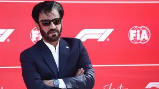 Mohammed Ben Sulayem in sunglasses against a F1 background