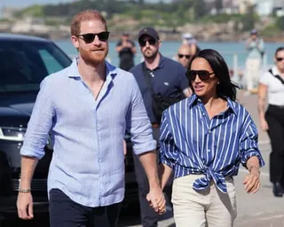 a husband and wife hold hands while walking outside