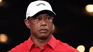 Tiger Woods sporting a red shirt and a white hat