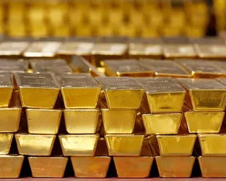 Rows of stacked gold bars fill a vault at the US Mint