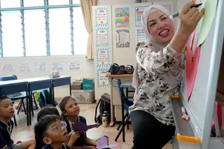 Hafizah Mahmud with her Primary 1 pupils from Si Ling Primary School during a lesson on showing care and kindness to others.