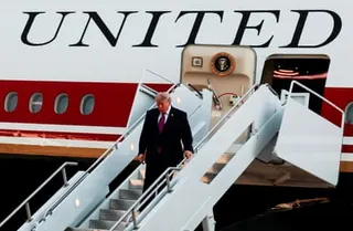 a man descends a staircase from a plane