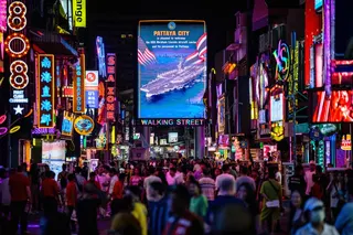 Pedestrians walk past a LED display welcoming the arrival of US service personnel of the nuclear-powered aircraft carrier USS Abraham Lincoln (CVN-72) in Pattaya September 2, 2026. — AFP pic