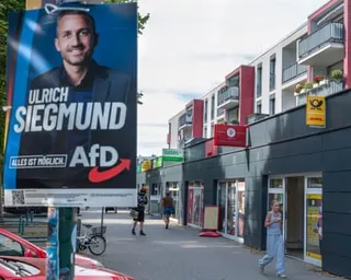 A billboard on a street showing the face of in AfD candidate Ulrich Siegmund