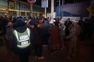 Military personnel evacuating civilians near the site of an explosion at an army barracks in Viacha, Bolivia, on Friday. Photo: AFP