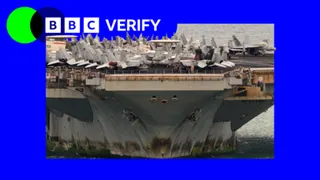 A photo of the the bottom half of the USS Lincoln with rust and algae on it, with war planes on top of the deck.