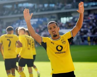 Ethan Nwaneri takes the plaudits from the Dortmund fans after his shot led to an Albian Hajdari own goal
