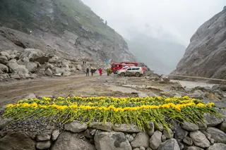 Flowers are laid at the core affected zone of the mudslide-hit Gyirong Port on Sunday. Photo: Xinhua